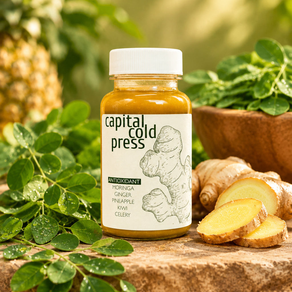 A bottle of Moringa Ginger - Antioxidant Booster by Capital Cold Press, with a white label featuring text and illustrations.